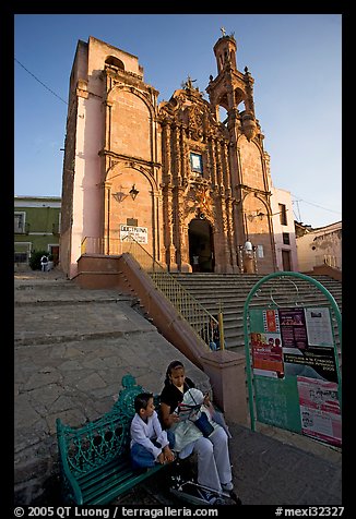 Woman and child waiting for bus below a church. Guanajuato, Mexico (color)