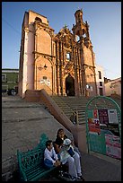Woman and child waiting for bus below a church. Guanajuato, Mexico