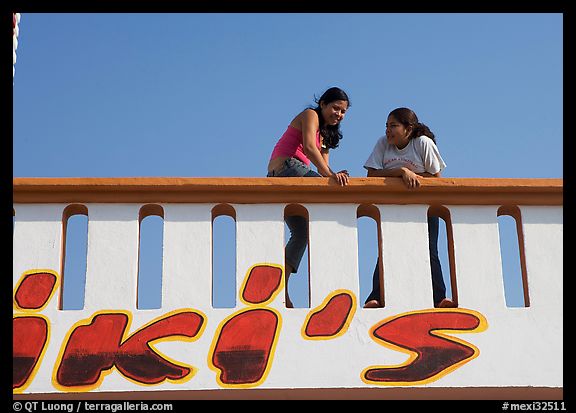 Young women sitting on a roof. Mexico (color)
