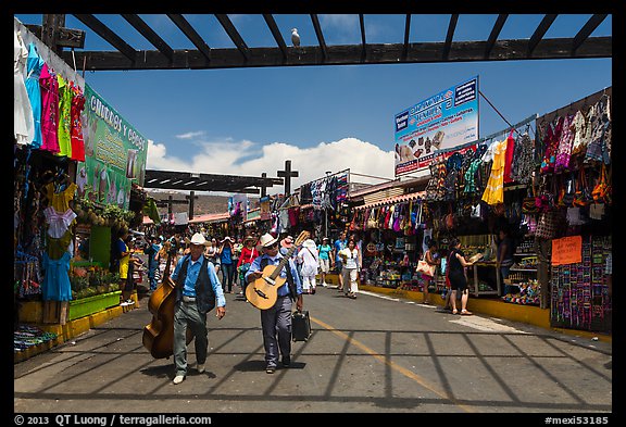 Musicians walking in flee market, La Bufadora. Baja California, Mexico