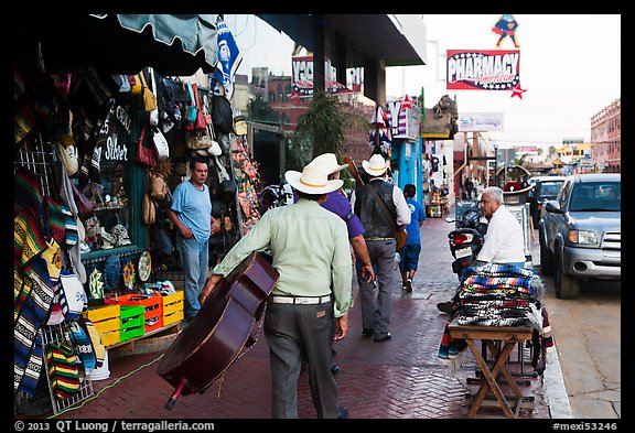 Musicians walking on street, Ensenada. Baja California, Mexico (color)