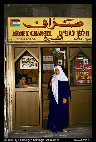 Muslem woman exiting a money changing booth. Jerusalem, Israel