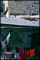 Laundry in a courtyard, with the Western Wall in the background. Jerusalem, Israel (color)