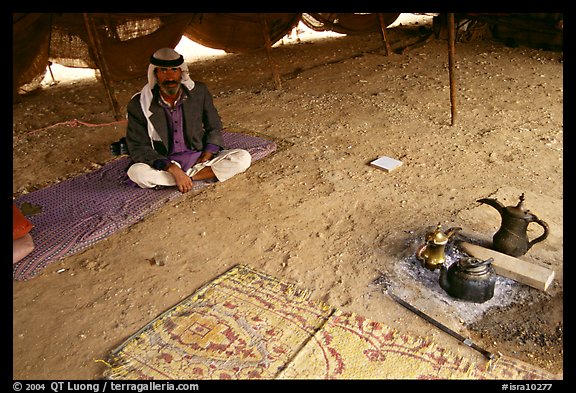 Bedouin man sitting on a carpet in a tent, Judean Desert. West Bank, Occupied Territories (Israel)