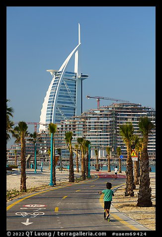 Kids, bike path and Burj Al Arab, Sunset Beach. United Arab Emirates (color)