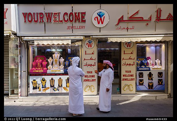 Men in front of jewellery, Gold Souk, Deira. United Arab Emirates (color)