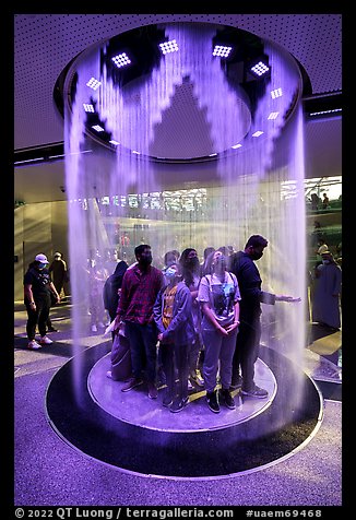 Visitors behind curtain of water, Saudi Arabia Pavilion. Expo 2020, Dubai, United Arab Emirates (color)