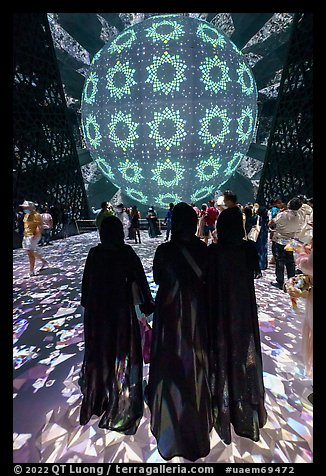 Women in abaya at light show, Saudi Arabia Pavilion. Expo 2020, Dubai, United Arab Emirates (color)