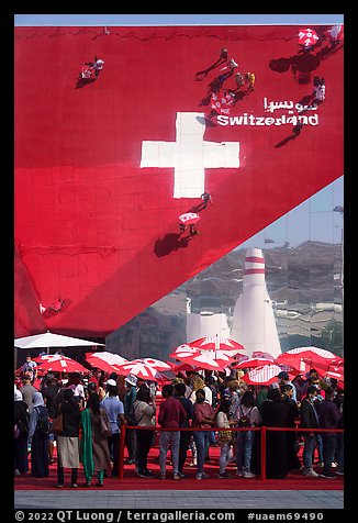 Visitors with umbrellas, Swizerland Pavilion. Expo 2020, Dubai, United Arab Emirates (color)