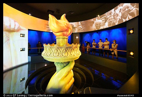 Visitors look at replica of Statue of Liberty torch, USA Pavilion. Expo 2020, Dubai, United Arab Emirates (color)