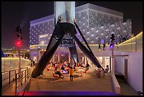 Booster rocket on landing legs and pavilion, USA Pavilion. Expo 2020, Dubai, United Arab Emirates ( color)