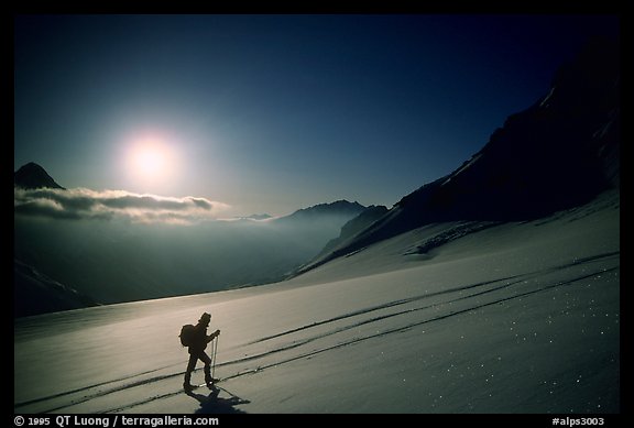 Backcountry skier climbs Dome de Chasseforet in the Vanoise Range, Alps, France.