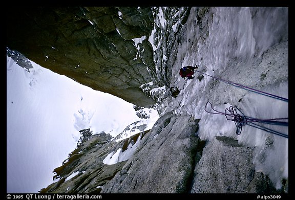 Climbers Frank and Alain climb thin ice in the Super-Couloir on Mt Blanc du Tacul, Mont-Blanc Range, Alps, France.