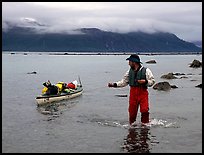 Kayaker tows kayak near Scidmore Bay. Glacier Bay National Park, Alaska (color)