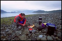 Kayaker firing up the stove,  Muir Inlet. Glacier Bay National Park, Alaska ( color)