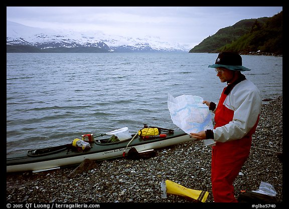 Kayaker looking at the map, East Arm. Glacier Bay National Park, Alaska (color)