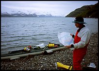 Kayaker looking at the map, East Arm. Glacier Bay National Park, Alaska ( color)