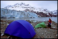 Campers set-up a tent in front of Lamplugh Glacier. Glacier Bay National Park, Alaska (color)