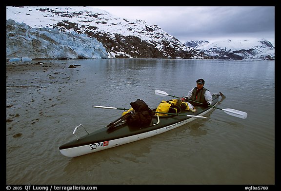 Kayaker sitting in loaded double kayak near Lamplugh Glacier. Glacier Bay National Park, Alaska