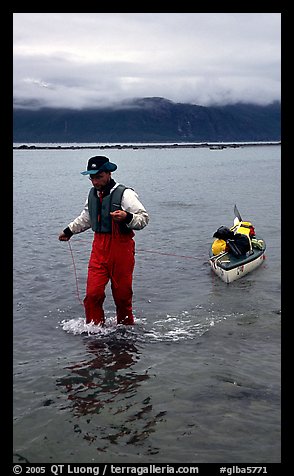 Kayaker towing kayak, East arm. Glacier Bay National Park, Alaska
