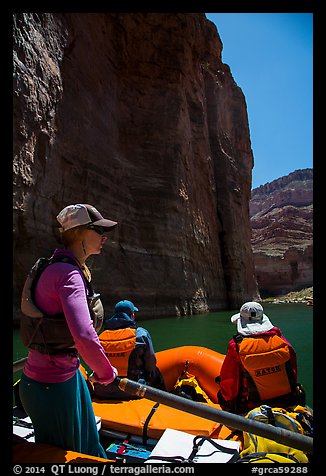 On raft below redwall limestone cliff dropping straight into Colorado River. Grand Canyon National Park, Arizona (color)