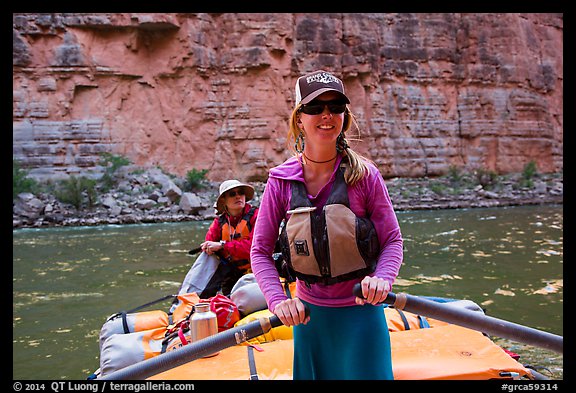 River guide rowing oar raft in narrow canyon. Grand Canyon National Park, Arizona