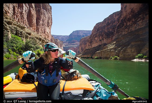 Woman rows raft on calm section of Colorado River, Marble Canyon. Grand Canyon National Park, Arizona (color)