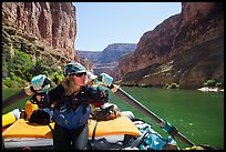 Woman rows raft on calm section of Colorado River, Marble Canyon. Grand Canyon National Park, Arizona ( color)