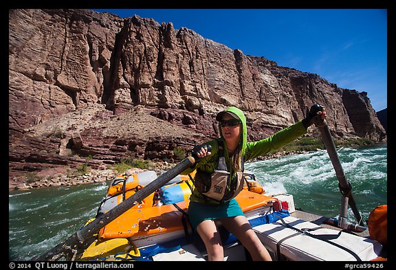 Woman stirring raft with oars in rapid. Grand Canyon National Park, Arizona (color)