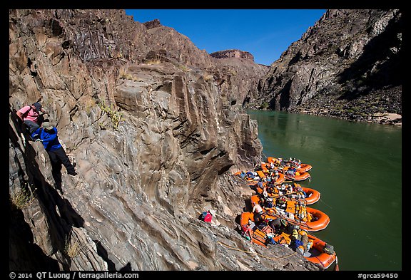 Scrambling on rocks towards rafts at the month of Clear Creek canyon. Grand Canyon National Park, Arizona