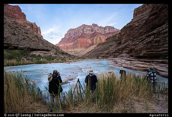 Photographers shooting from riverbank grasses at dawn, with the Little Colorado River in view. Grand Canyon National Park, Arizona (color)