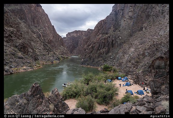 Aerial view of a riverside camp with blue tents and boats along the Colorado River at Ninetyone mile. Grand Canyon National Park, Arizona (color)