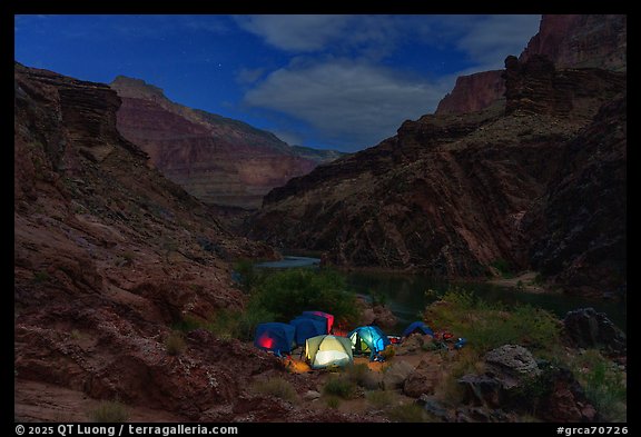 Night scene of illuminated tents at a remote campsite on the Colorado River. Grand Canyon National Park, Arizona (color)