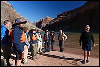 Group of rafters wearing life jackets gathered for a safety talk along the Colorado River on a Grand Canyon rafting trip. Grand Canyon National Park, Arizona ( color)