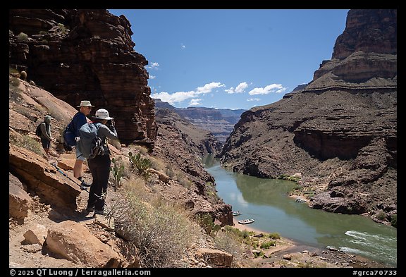 Hikers on a canyon trail overlook the Colorado River far below during a Grand Canyon backcountry excursion.. Grand Canyon National Park, Arizona (color)