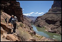 Hikers on a canyon trail overlook the Colorado River far below during a Grand Canyon backcountry excursion.. Grand Canyon National Park, Arizona ( color)