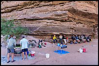 Group of rafters relaxing in the shade of a rock overhang while crew prepares lunch. Grand Canyon National Park, Arizona ( color)
