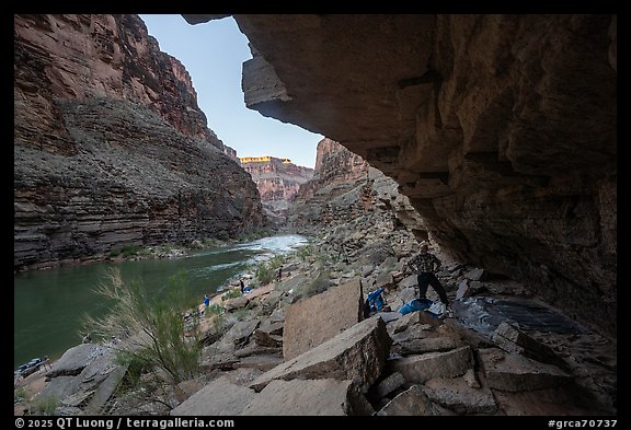 River rafters setting up camp beneath a rock overhang along the Colorado River. Grand Canyon National Park, Arizona (color)