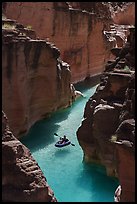 Inflatable kayak floating in clear turquoise water through a narrow canyon of Havasu Creek. Grand Canyon National Park, Arizona ( color)