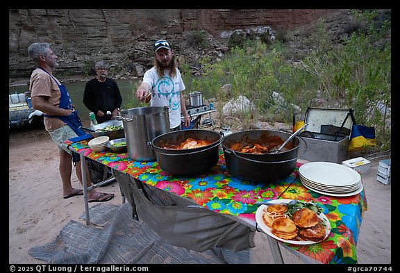 Dinner being served at outdoor kitchen along the Colorado River during a Grand Canyon rafting trip. Grand Canyon National Park, Arizona (color)