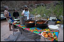 Dinner being served at outdoor kitchen along the Colorado River during a Grand Canyon rafting trip. Grand Canyon National Park, Arizona ( color)