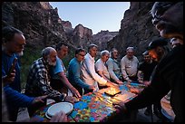 Rafters gathered around a birthday cake celebration at dusk. Grand Canyon National Park, Arizona ( color)
