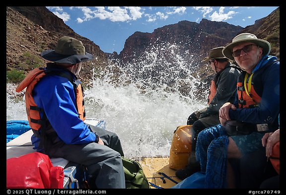 Splash from a rapid hits passengers on a Grand Canyon raft, capturing the thrill of whitewater on the Colorado River. Grand Canyon National Park, Arizona (color)