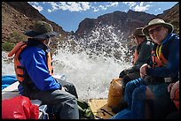 Splash from a rapid hits passengers on a Grand Canyon raft, capturing the thrill of whitewater on the Colorado River. Grand Canyon National Park, Arizona ( color)