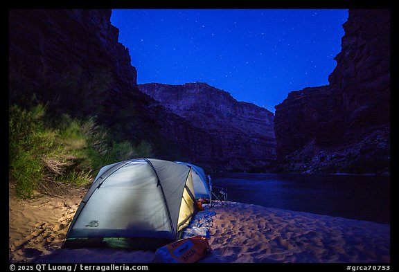 Lighted tent on beach along the Colorado River at night. Grand Canyon National Park, Arizona (color)