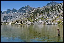 Young man in alpine lake, lower Dusy Basin. Kings Canyon National Park, California