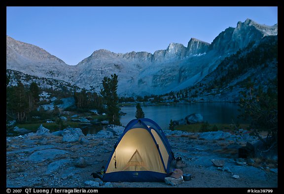 Tent with light and Palisades at dusk, lower Dusy Basin. Kings Canyon National Park, California, USA.