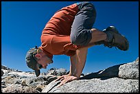 Hiker balancing on hands on rock, Bishop Pass. Kings Canyon National Park, California (color)
