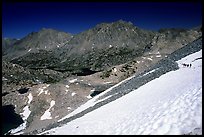 Backpackers on a snow field at a high pass. Kings Canyon National Park, California (color)