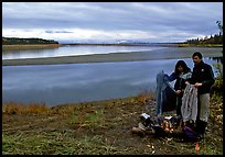 Canoeist drying out clothing over a campfire. Kobuk Valley National Park, Alaska ( color)